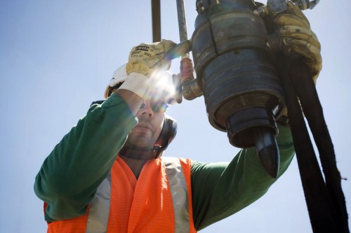 Photographie industrielle d'un homme au travail sur une tête de puits. Reportage industriel réalisé pour Storengy. | Philippe DUREUIL Photographie