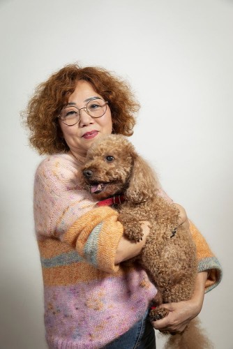 Portrait artistique d'une femme avec son caniche dans les bras. Photo de portrait lifestyle en studio sur fond blanc. | Philippe DUREUIL Photographie